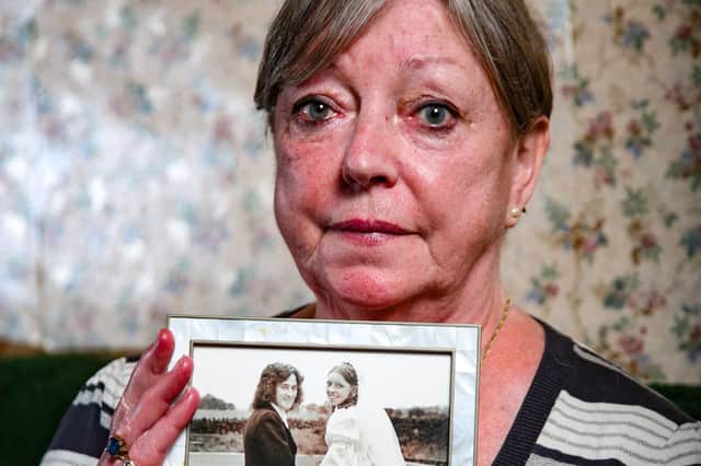 Katrina Lofthouse, 71, holding a photo of her late husband Ian Lofthouse on their wedding day