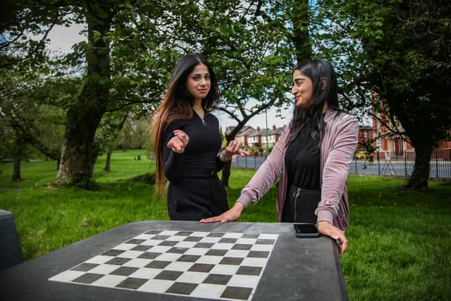 (L to R) Laiba Amjad, 20, and Marwa Ahmed, 22, at the chess board in Farnworth Park.