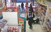 This is the shocking moment a prolific shoplifter barged over two elderly woman after stealing frozen lamb from Iceland.  