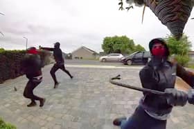 Balaclava-clad men at Nikia's address in Doncaster, South Yorks, who smashed the front door with a crowbar (Credit: SWNS/ Nikia Marshall)