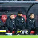 Vincent Kompany watches on from the dug out with Craig Bellamy and Mike Jackson