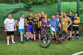 March being gifted his new bike by players at Senior Soccer.