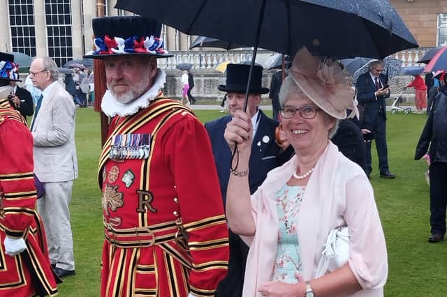 Val enjoying her day at the garden party despite the rain.