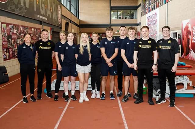 Students stand with Wigan Warriors physiotherapy and sports therapy staff