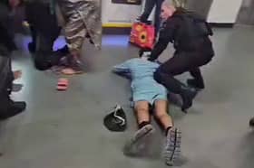 A screen-grab from a video that shows a man being kicked by GMP officers at Manchester Airport 