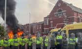 A police van set alight as trouble flares during a protest in Southport