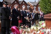 Prime Minister Sir Keir Starmer observes the floral tributes near the scene in Hart Street, Southport