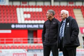 Preston North End manager Ryan Lowe chats to director Peter Ridsdale on the pitch