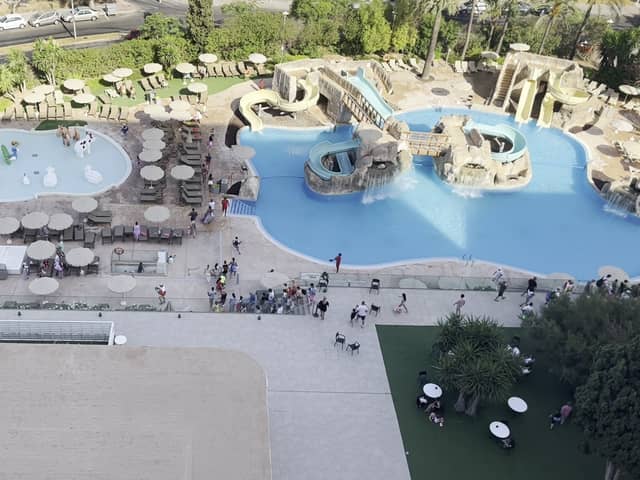 Tourists race to get sunbeds after queuing for pool to open.