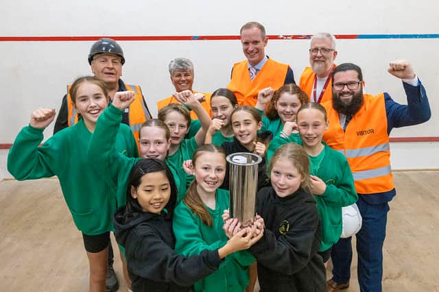 Pupils from Burscough Village Primary School, together with representatives from West Lancashire Borough Council and development partner Alliance Leisure, show off the time capsule they filled with their own artwork, which will now be buried during the Â£3.18m refurbishment of Burscough Sports.