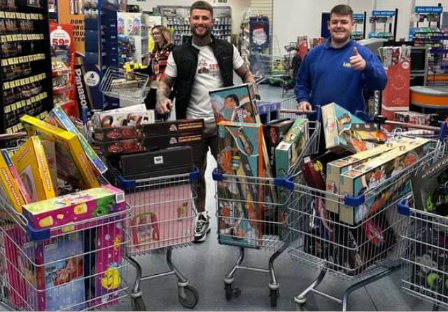 Byron Highton (left) and Mikey McGuiness (right) with gifts from last year's Christmas giveaway.