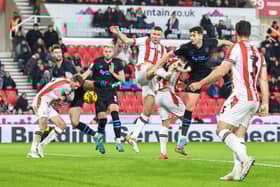 Preston North End's Jordan Storey heads the ball at goal under pressure from Stoke City's Ben Gibson