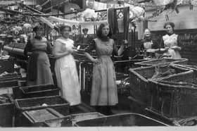 This Christmas scene was taken inside Preston's famous Horrockses Mill. We think it dates from around 1913.The winder in the white apron in the foreground is Mrs Elliott, mother of reader Mrs D McDermott who kindly sent in the photograph.