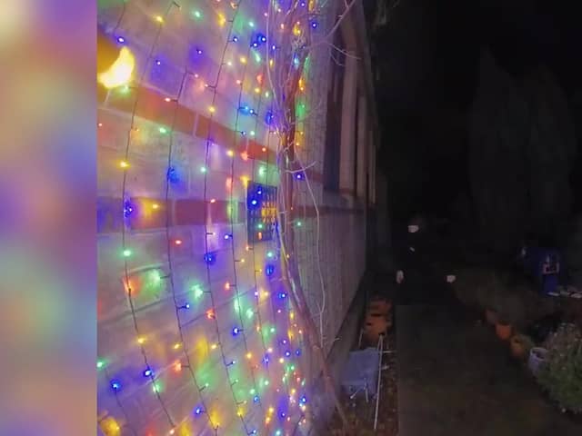 Video grab of a man snipping the Christmas lights at a property in Suffolk. 