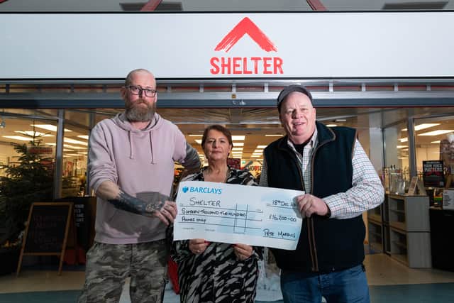 Michael Hackett, Assistant manager Lisa Lane, Manager at Shelter with a cheque presented to them by Pete Marquis.