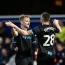 Ali McCann and Milutin Osmajic celebrate