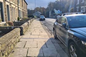 The gully can be seen dug out of the footpath, leading to the car