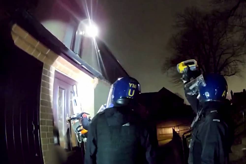 Police used a chainsaw to raid a drug house where they arrested a 13-year-old boy on suspicion of having a zombie knife. 
