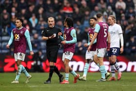 Match referee Andrew Kitchen speaks to Hannibal Mejbri during today's game against Preston North End