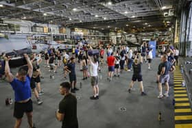 Here are all the details about the Royal Navy's Pre-Joining fitness test, and how you can beat it. Pictured are HMS Queen Elizabeth's ship's company take part in circuits in the hangar.