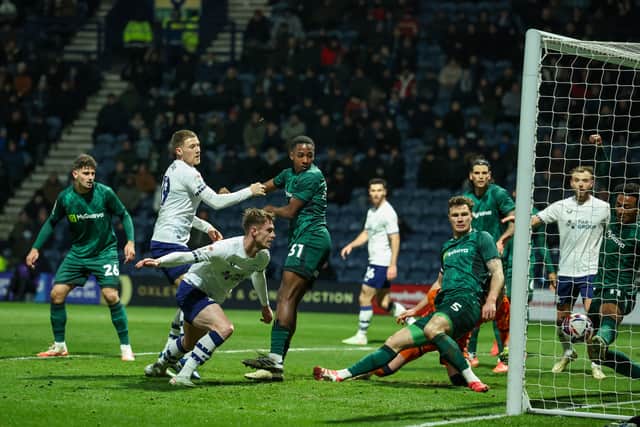 Liam Lindsay heads at goal