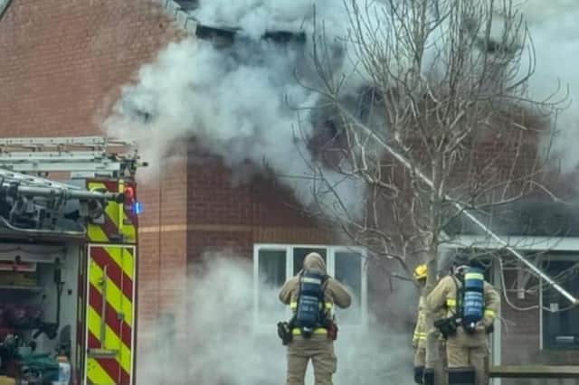 Firefighters tackle the blaze.
