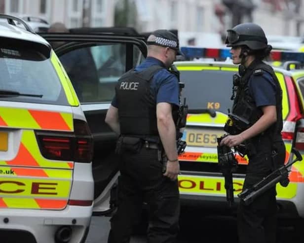 Teenagers arrested and man in hospital as armed police swoop on street