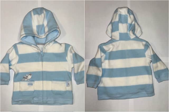 The front and back of the blue and white striped George ASDA fleece top which the baby born was dressed in