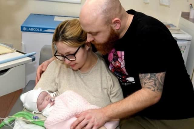 Shannon Lord, 27, and Dayle Newton, 36, with baby Ayla shortly before her tragic death. "We had to make the decision to withdraw her care as a result of severe brain damage. We sat with our girl in our arms for eleven hours watching her slowly die."
