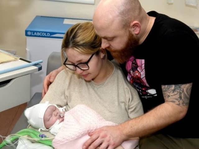Shannon Lord, 27, and Dayle Newton, 36, with baby Ayla shortly before her tragic death. "We had to make the decision to withdraw her care as a result of severe brain damage. We sat with our girl in our arms for eleven hours watching her slowly die."