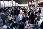 People wait outside the Atocha train station in Madrid after its closure as a massive power outage hits Spain.
