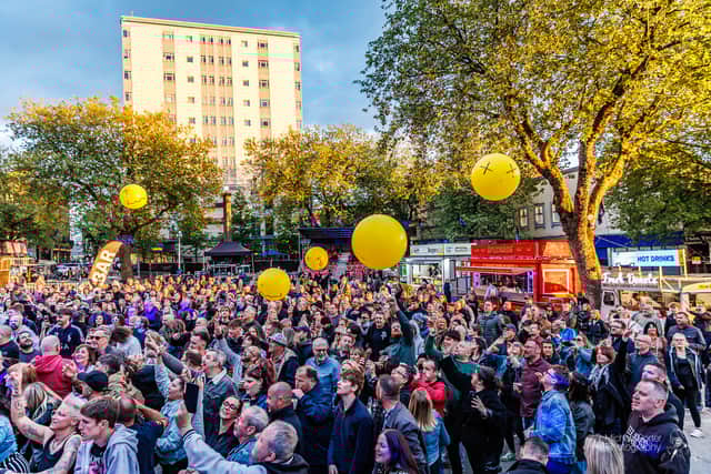 The crowd enjoying the music whilst the sun was still shining.