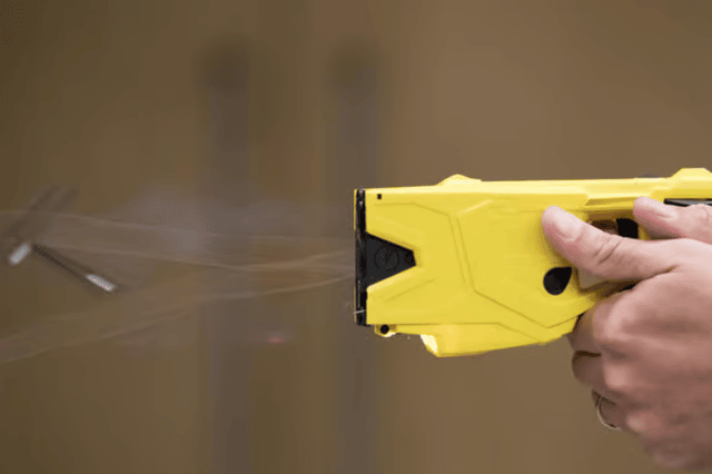 A Taser was fired during the street fight - but that didn't stop the officer intervening