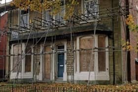 The vacant and boarded up 61 Infirmary Road.