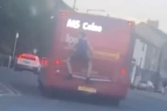 The teenager was filmed 'bus surfing' in Colne, Lancashire on Sunday (May 11)