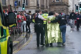 Police and emergency personnel dealing with an incident near the Liver Building in Liverpool during the Premier League winners parad
