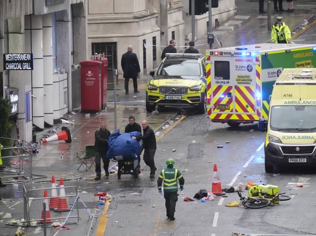 Police and emergency personnel dealing with a road traffic accident on Water Street near the Liver Building in Liverpool after a car collided with pedestrians during the Premier League winners parade