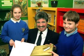 Graham Robinson is retiring after 13 years as headteacher at Moor Nook Primary School, Preston. He is pictured here receiving his leaving gift from pupils Laura Booth and Keith Stocks.