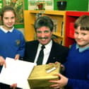 Graham Robinson is retiring after 13 years as headteacher at Moor Nook Primary School, Preston. He is pictured here receiving his leaving gift from pupils Laura Booth and Keith Stocks.