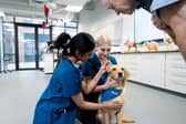 Meg the dog with students Emma Saxby and Hiya Shroff