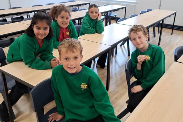 Pictured from left to right on the back row are at Lea Community Primary School after the £3.5m expansion which will double pupil intake are: pupils Alara, Etta and Samaira, and on the front row, from left to right are Vinny and Samuel