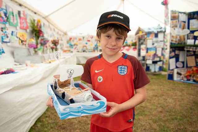 Edward Chesham with his boat sculpture, made out of recycled materials, which won 3rd prize in the children's section for creative crafts. Photo: Lucinda Herbert