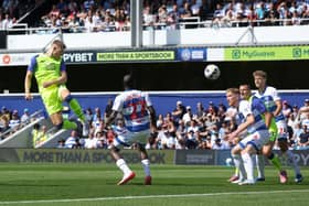 Lewis Gibson heads at goal