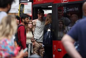 Passengers squeeze onto a red London bus outside Victoria Station London, in August 2022 (Photo: HOLLIE ADAMS/AFP via Getty Images)