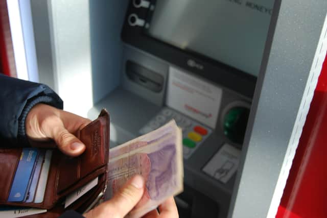 Police have issued a warning after reports a group of men have been hanging around town-centre cash machines in East Lancashire