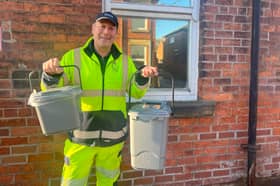 A refuse worker shows off the new food waste caddies that will soon be distributed to households across Preston