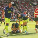 Preston North End's Liam Lindsay (grounded) is mobbed by team-mates after scoring his side's second goal with another first half header