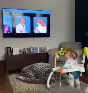 As Preston Davey bobbed in front of the TV, two characters on the screen sing 'the daddies on the bus say 'I love you.' The video was captured on Jamie Varley's phone and shared with his mother Karen Graham on WhatsApp.