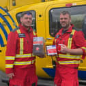 North West Air Ambulance workers proudly hold up some Lancashire Tea boxes.