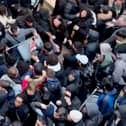Chaos erupted and 'fights' broke out at Manchester's Trafford Centre shopping centre as crowds of people try to get their hands on a limited-edition watch. 